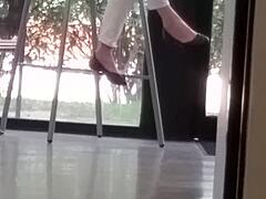 mature woman engages in shoe play with feet and shoes