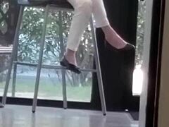 mature woman engages in shoe play with feet and shoes