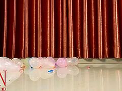 milf in lingerie pops small balloons with high heels while dominating with feet