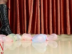 milf in lingerie pops small balloons with high heels while dominating with feet