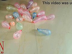 milf in lingerie pops small balloons with high heels while dominating with feet