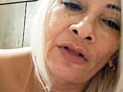 Milf plays with dildo in naked pussy.