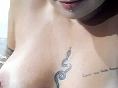 Rasta woman enjoys a fun bath in the bathtub.