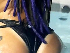 Rasta woman enjoys a fun bath in the bathtub.