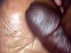 girlfriend gives footjob to boyfriend in bedroom, teasing with feet and hands.