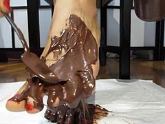 the goddess shows her petite feet covered in chocolate cream in the garage pov