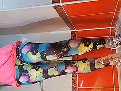 Babe with natural tits uses dildo for masturbation in gym shower, close up on tits and pee