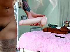 cute blonde in pink suit riding a massive dildo so hard