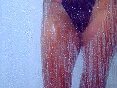 college tanned gorgeous girl feels relaxed taking a shower in her bikini