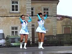 Two nice majorettes performing in their cheerleader outfits