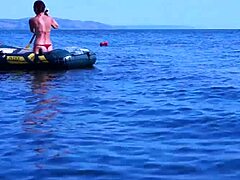 Mature woman in bikini on Volga River boat