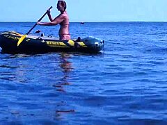 Mature woman in bikini on Volga River boat
