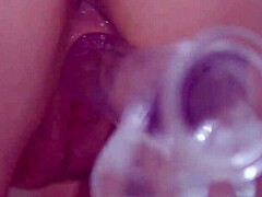 Natural busty redhead feels deep emotions during solo masturbation with clear dildo close up