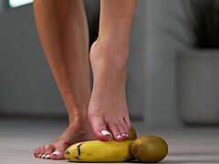 petite brunette girl casually crushes fruits with high heels in hot footfetish solo scene, showing off her feet and shoes softly