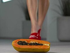 petite brunette girl casually crushes fruits with high heels in hot footfetish solo scene, showing off her feet and shoes softly