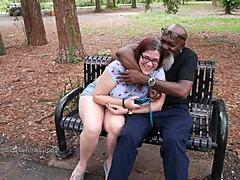 nerdy milf strokes and sucks big black dick in the park with glasses on