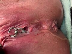 Why is this pierced clit getting rubbed hard in latex gloves before a strong pee stream?