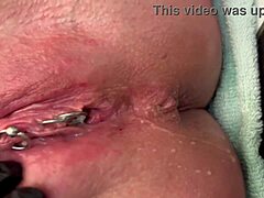 Why is this pierced clit getting rubbed hard in latex gloves before a strong pee stream?