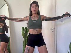 ever tried rubber band yoga with an inked fitness babe?