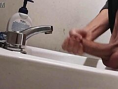 skinny dude rests huge balls on sink preps monster cock for massive cumshot