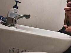 skinny dude rests huge balls on sink preps monster cock for massive cumshot