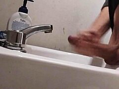 skinny dude rests huge balls on sink preps monster cock for massive cumshot