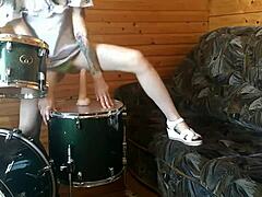 Watch this petite brunette teen fuck her tight pussy deep with a huge dildo right on the drumset