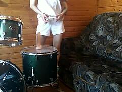 Watch this petite brunette teen fuck her tight pussy deep with a huge dildo right on the drumset